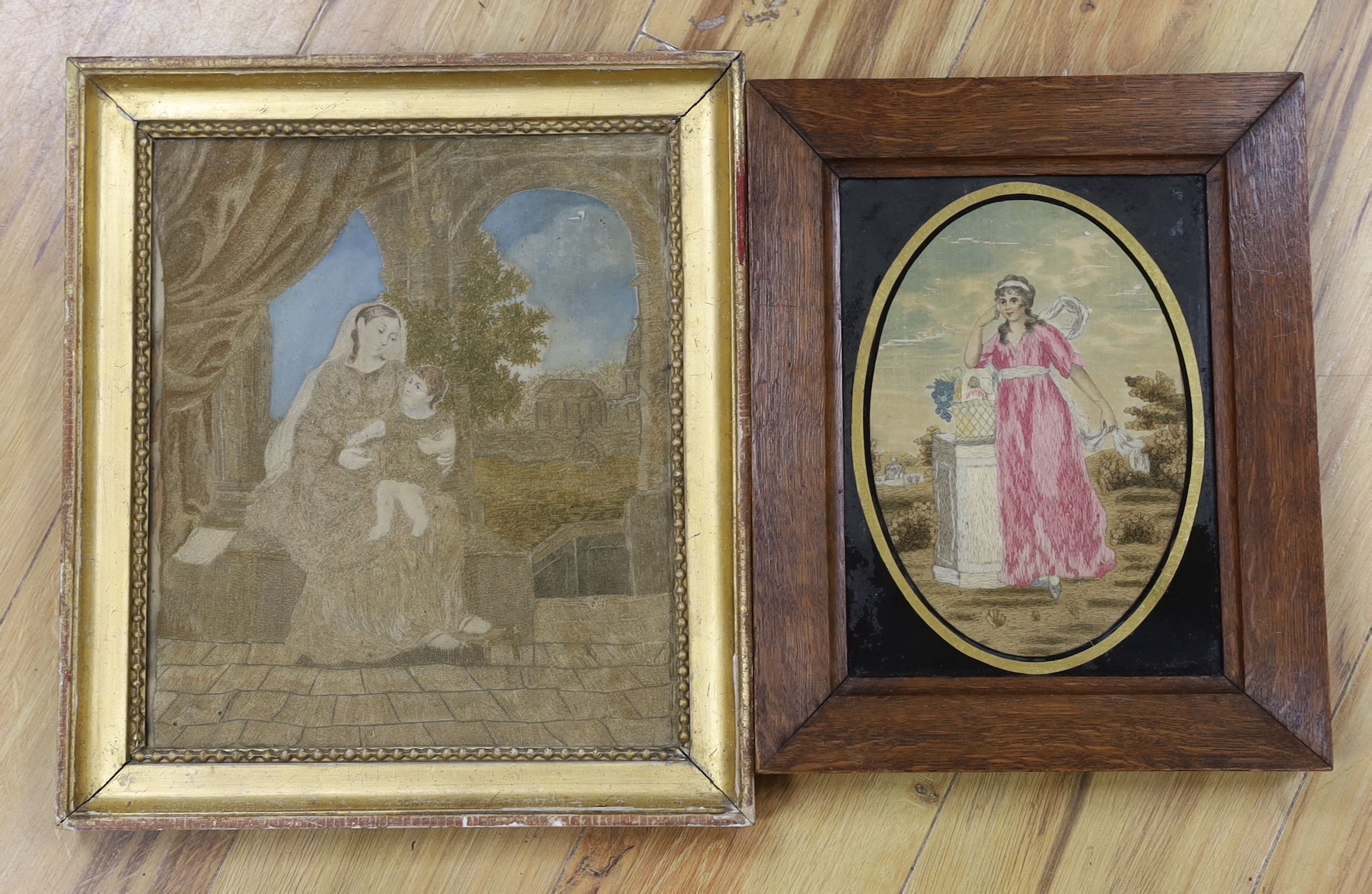 Two framed Regency silk and wool-worked religious panels, one of Mary and baby Jesus and the other of a lady in a garden by a pillar, largest 27cm wide x 31cm high